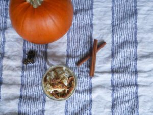pumpkin pie overnight oats with chia seeds, sugar pumpkin, and cinnamon sticks