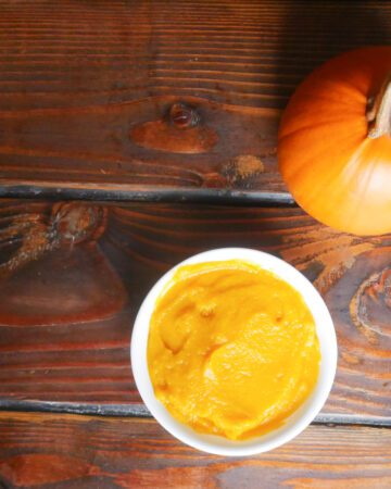 instant pot pumpkin puree in bowl next to sugar pumpkin