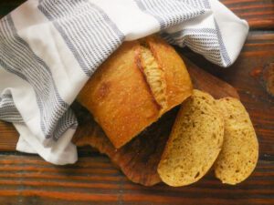 sliced up pumpkin sourdough bread on a cutting board