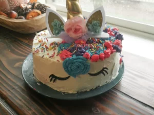 sourdough chocolate cake with frosting and a unicorn horn