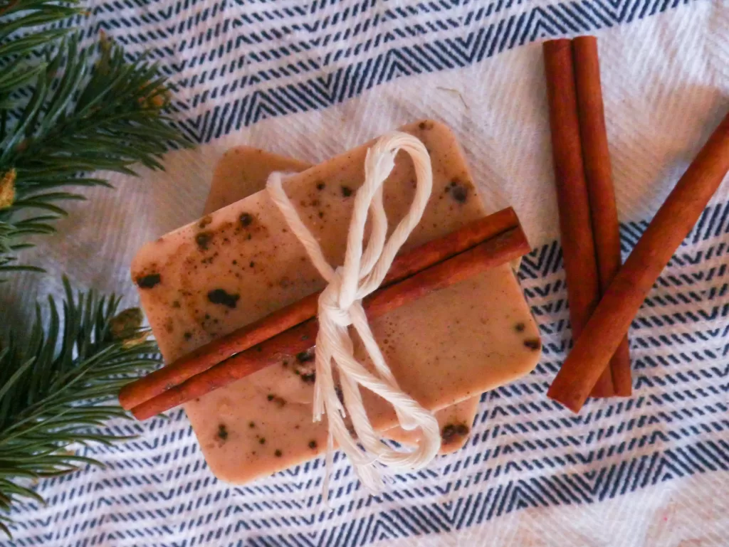 cinnamon stick tied with twine on homemade melt and pour cinnamon roll scented soap