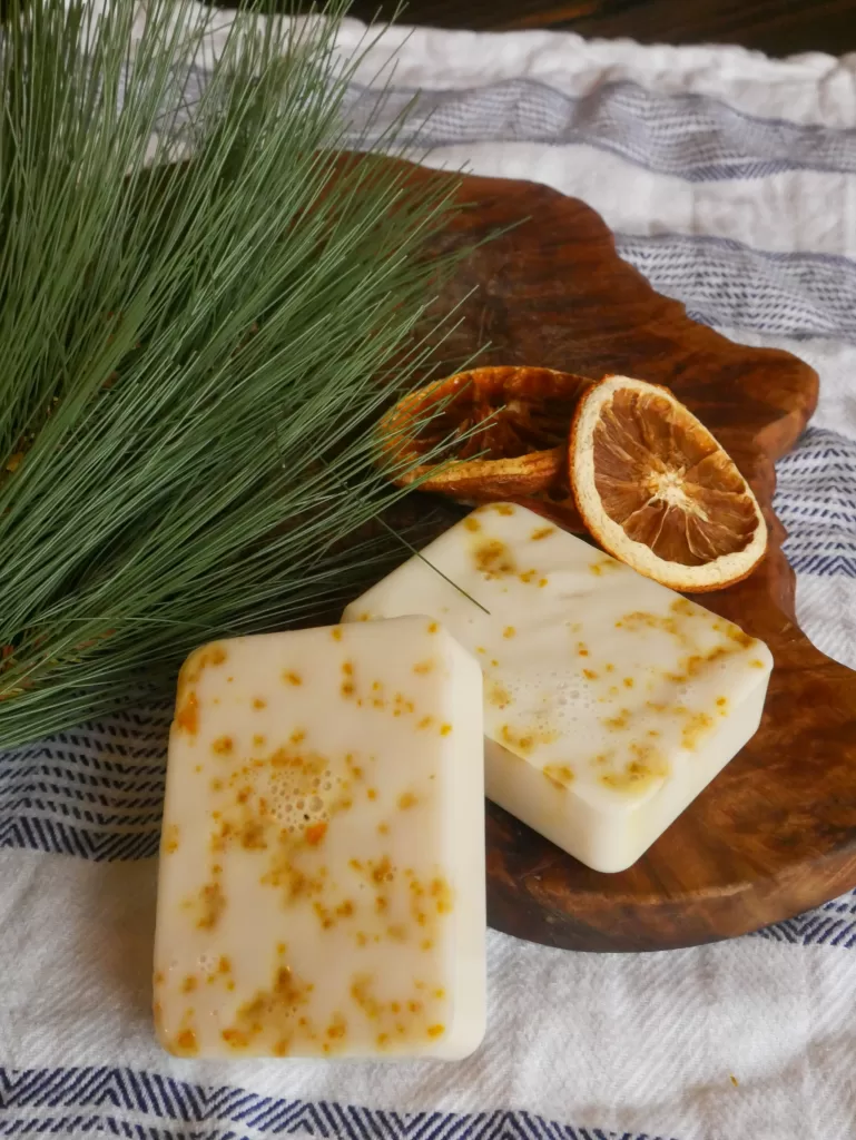 Christmas scented, spiced vanilla, melt and pour soap with dried oranges sitting next to them