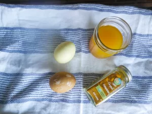 naturally dyed easter eggs next to a jar a turmeric