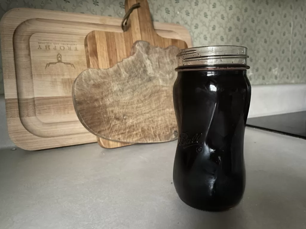 homemade elderberry syrup in a glass mason jar