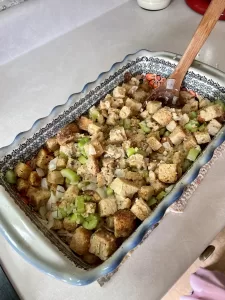 unbaked sourdough stuffing in a colorful polish pottery casserole dish