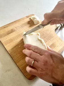 hands cutting up mango butter