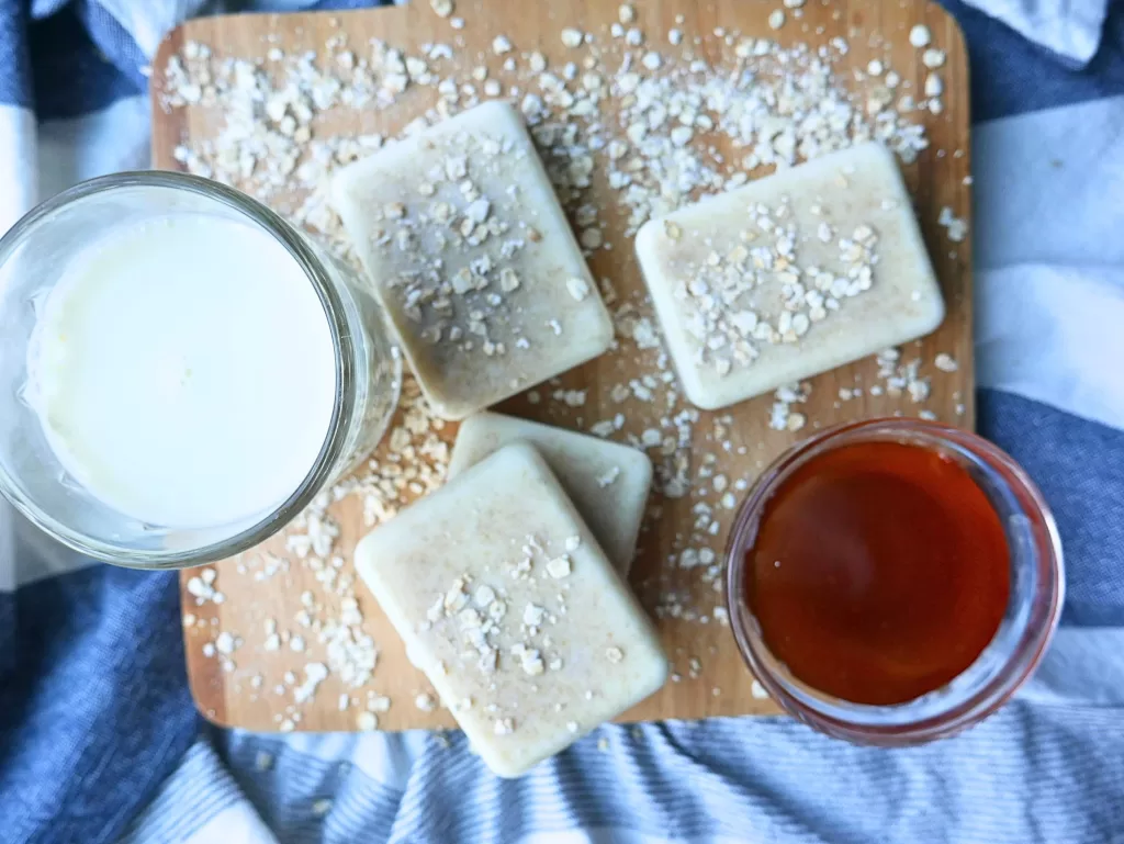 homemade soap with a glass of milk and small glass of honey