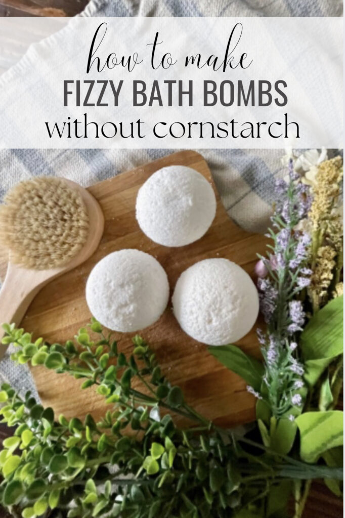 dry brush and homemade bath bombs without cornstarch sitting on wooden cutting board