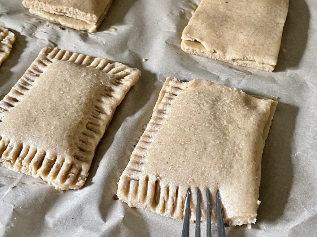fork pressing sides closed on sourdough fresh milled flour pop tarts