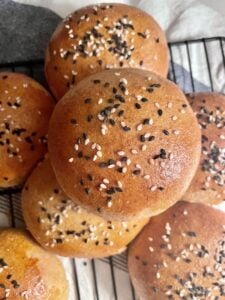 sourdough discard hamburger buns with fresh milled flour stacked on top of each other