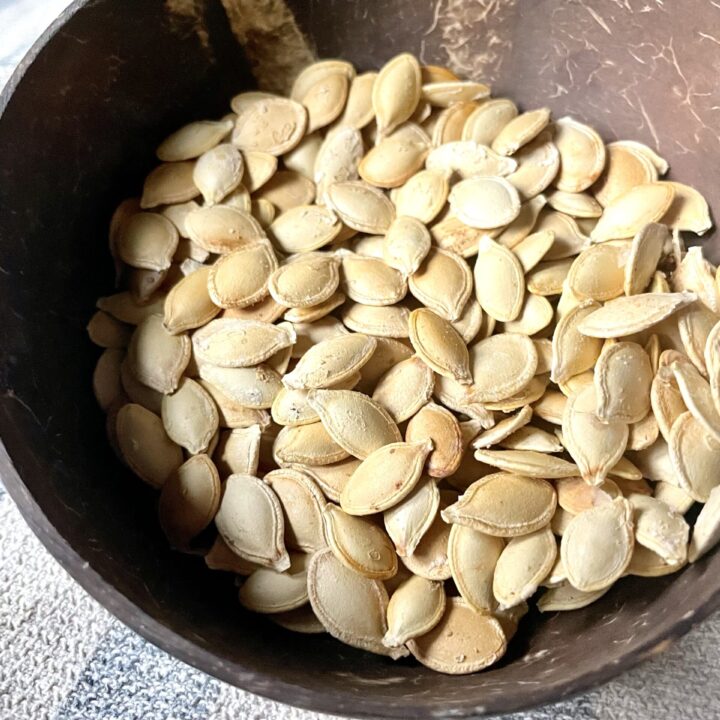 roasted pumpkin seeds without oil in brown coconut bowl