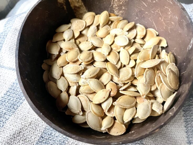 roasted pumpkin seeds without oil in brown coconut bowl