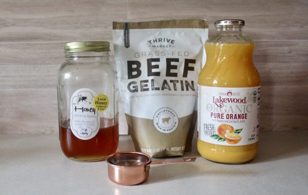 ingredients to healthy orange jello: water, honey, beef gelatin, and orange juice