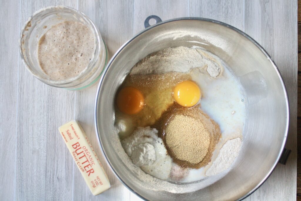 unmixed ingredients for cinnamon rolls in stand mixer bowl