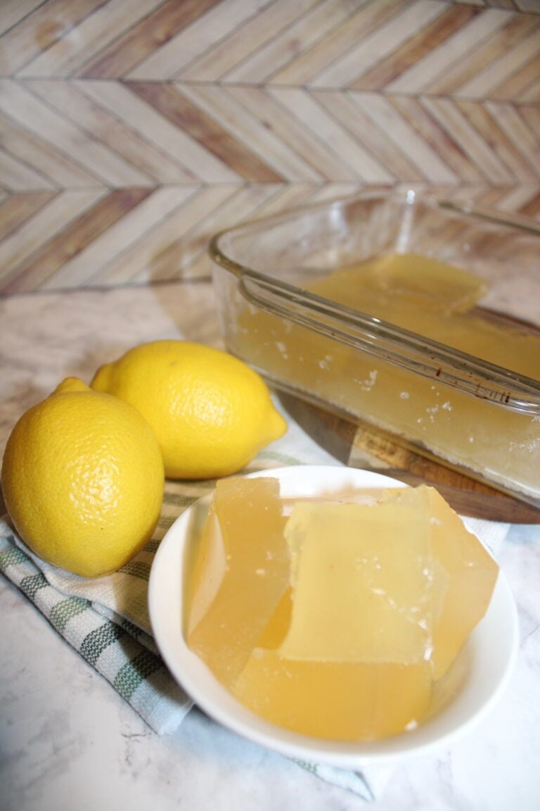 lemons behind a small bowl with cubed beef gelatin lemon jello