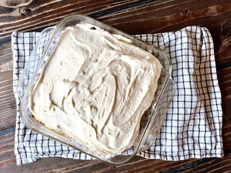 fresh milled flour buttermilk carrot cake with cream cheese frosting in a glass pan